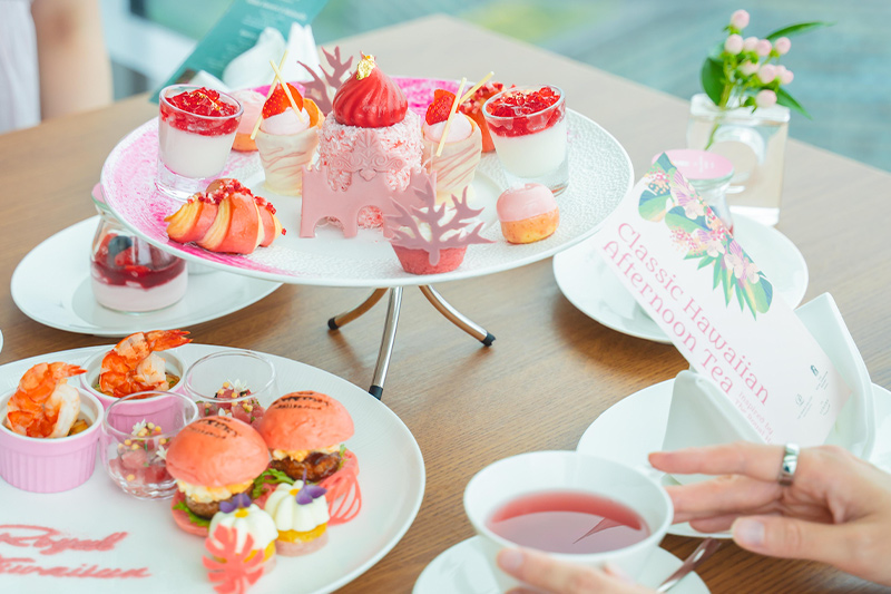 Afternoon tea stand with colorful pastries and finger sandwiches